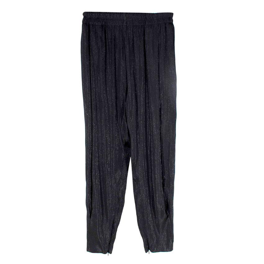 Gucci Black Sparkly Twill Tapered Trousers
 

 - Lightweight black twill trousers with a metallic thread running through
 - Deep elasticated waistband
 - Ankle zip
 - Partially lined
 

 Materials:
 43% Rayon
 39% Silk
 18% Polyester
 

 Made in
