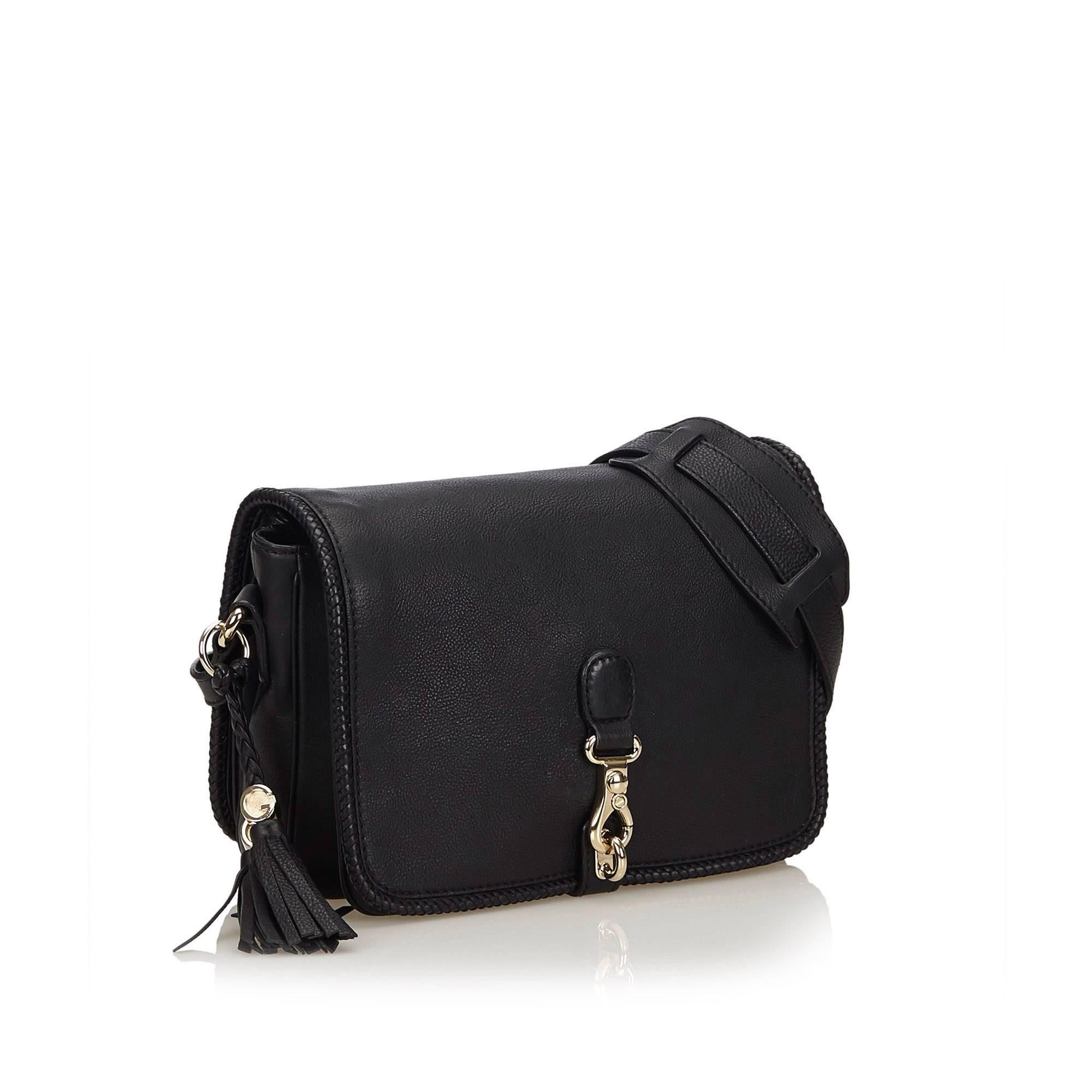 The Marrakech Messenger Bag features a leather body, tassel detail, flat strap, front flap with clasp closure, four interior compartments, and interior zip and slip pockets. 

It carries an A condition rating.

Dimensions: 
Length 20 cm
Width 30