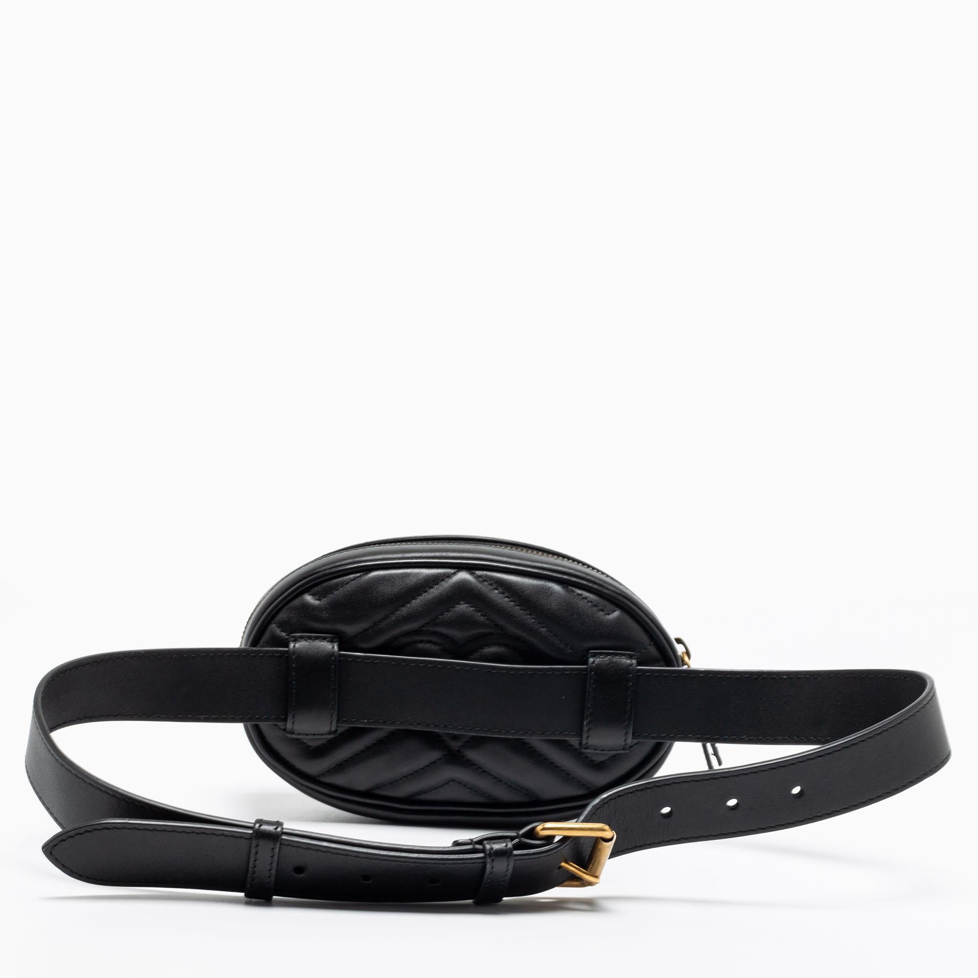 The GG Marmont belt bag was released in the brand's Pre-Fall 2017 collection, and it went on to be a hit! This one here in black matelassé leather has the signature oval-like shape and is equipped with a zipper fastening to secure the well-sized