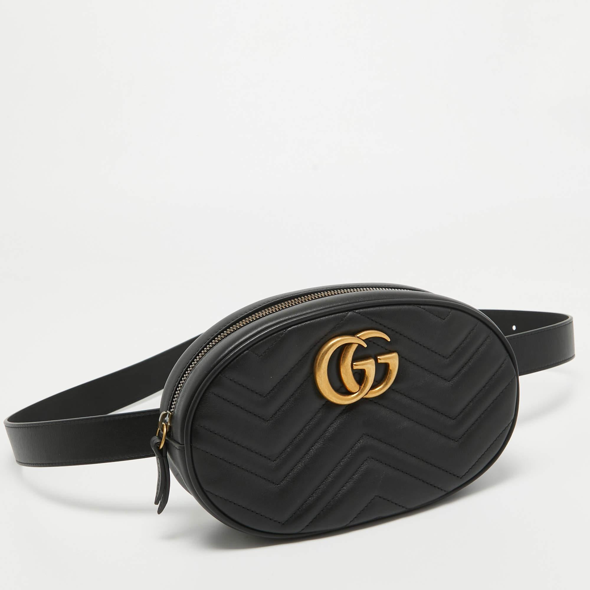 The Gucci belt bag is a luxurious accessory featuring signature matelassé quilting and the iconic GG logo. Crafted from black leather, it boasts a stylish belt design for versatile wear and a spacious compartment for essentials, combining fashion