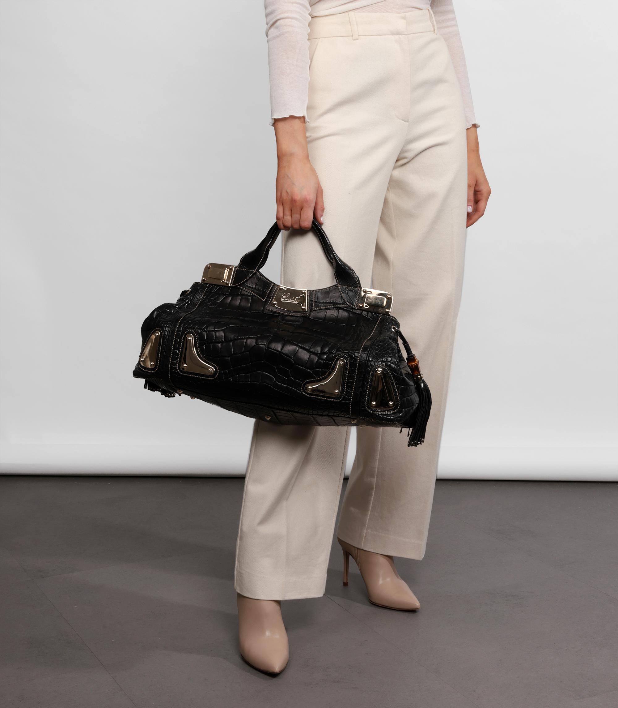 Gucci  Black Matte Alligator Leather Large Tassel Race Tote

Product Details
Xupes Ref: CB1206
Brand: Gucci
Model:  Large Race Tote
Type: Tote
Serial Number: 177091 002122
Accompanied By: Gucci Dust Bag
Colour: Black
Hardware: Champagne