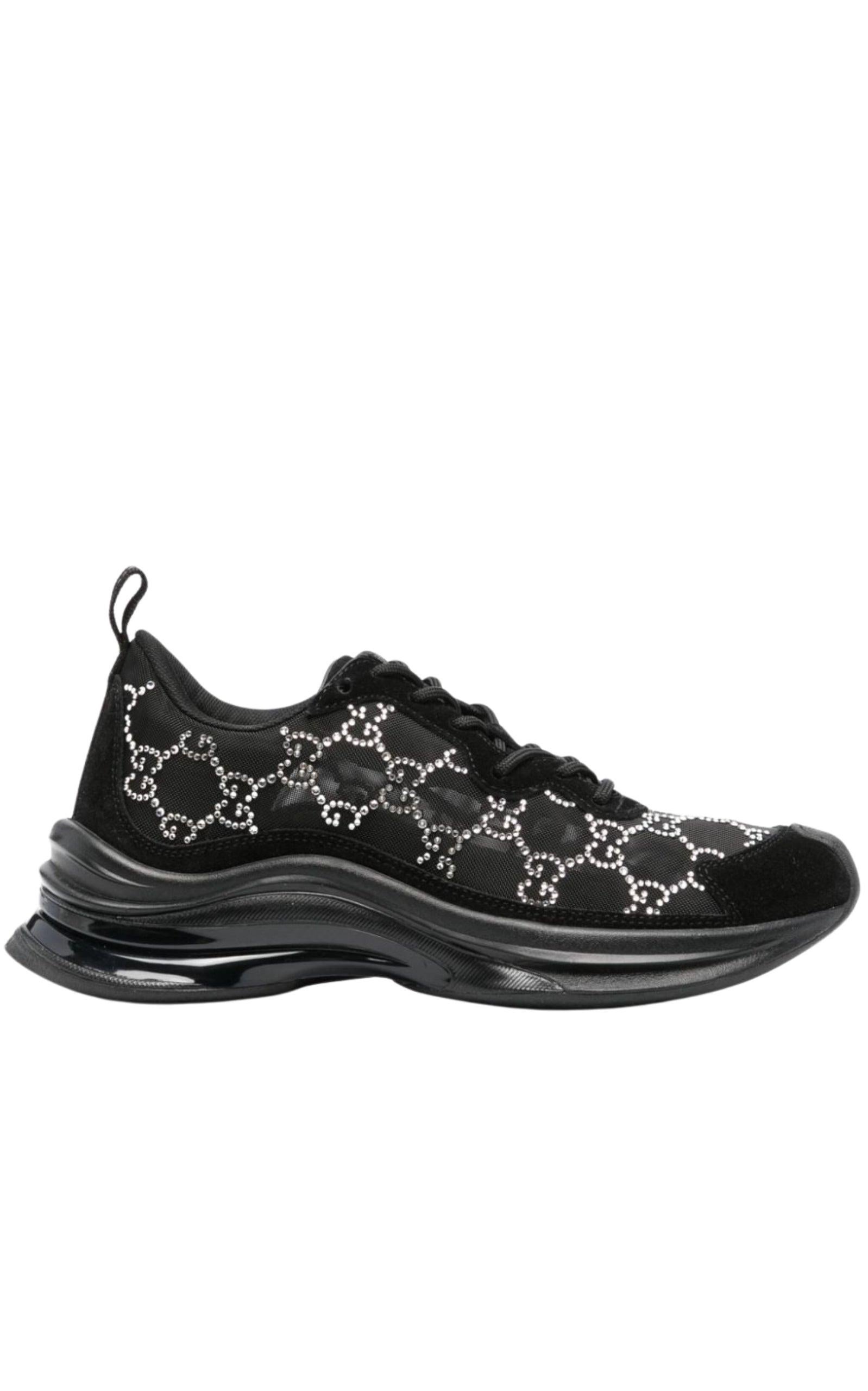Elevate your sneaker game with these stylish Black Mesh Runners with Crystals from Gucci. Featuring a flat heel, round toe, and lace-up vamp, these sneakers also have a cushioned footbed and rubber outsole for ultimate comfort. The mesh design is