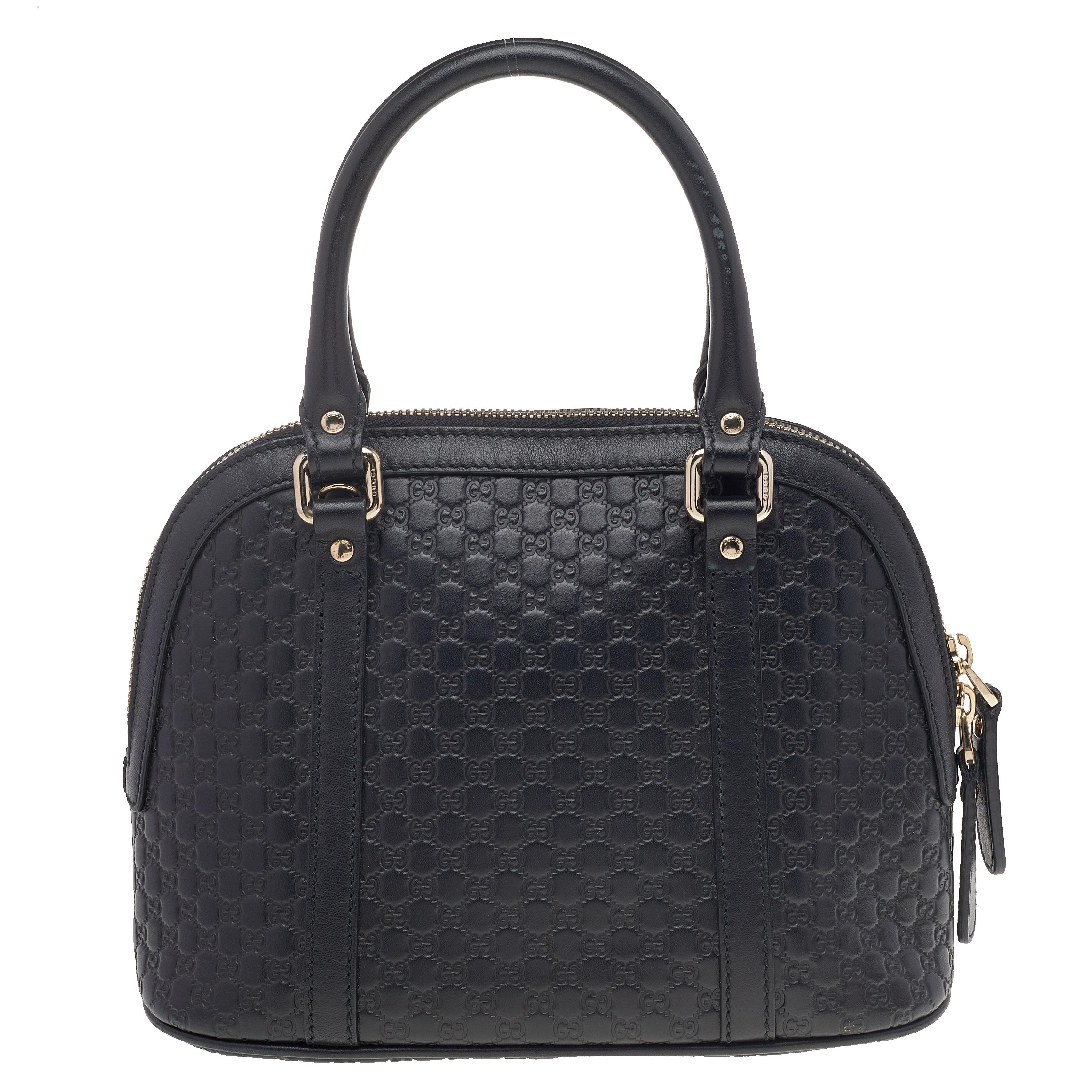 Acquire a smart look wearing this Mini Dome bag that has come from the house of Gucci. Its black color exudes a subtle vibe, and Microguccissima leather speaks out for grace and softness. The versatility lies in the dual-rolled handles and long