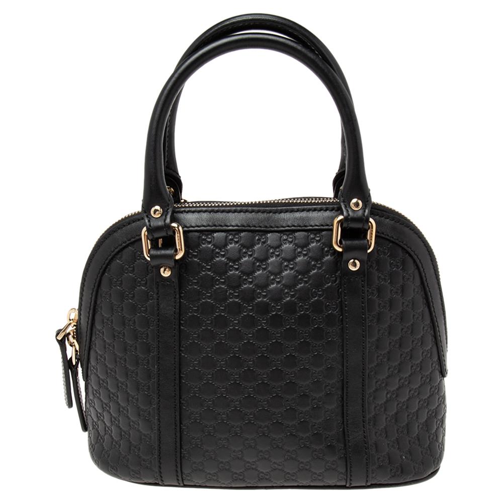 This mini Dome bag from the House of Gucci is an absolutely beautiful creation. Crafted using black Microguccissima leather, this bag features gold-toned hardware with dual handles. The zipper leads us to the spacious canvas-lined interior. Make a