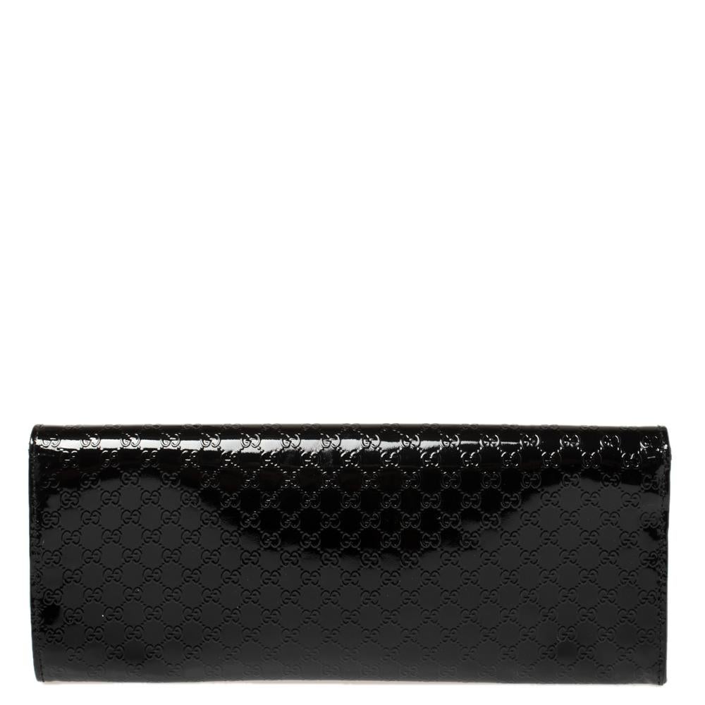 A must-have for all Gucci lovers! This Broadway clutch is crafted from patent leather with Microguccissima embossing and is provided with minimal gold-tone hardware. The flap closure with concealed magnetic fastening secures its leather and