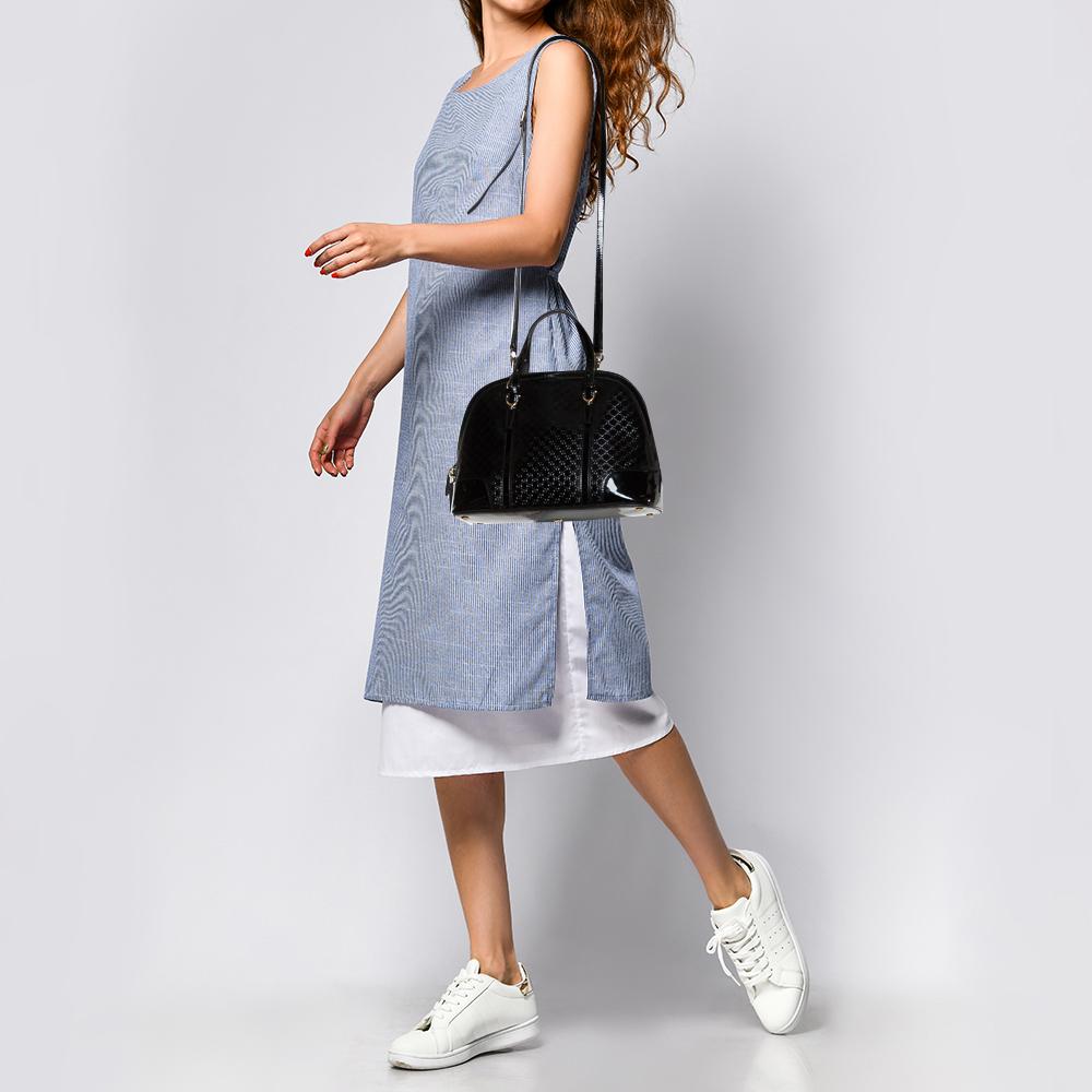 This stylish Nice bag from Gucci is crafted from Microguccissima patent leather. The bag has a structured silhouette and comes with dual top handles and protective metal feet at the bottom. The dual zip closure opens to a canvas-lined interior