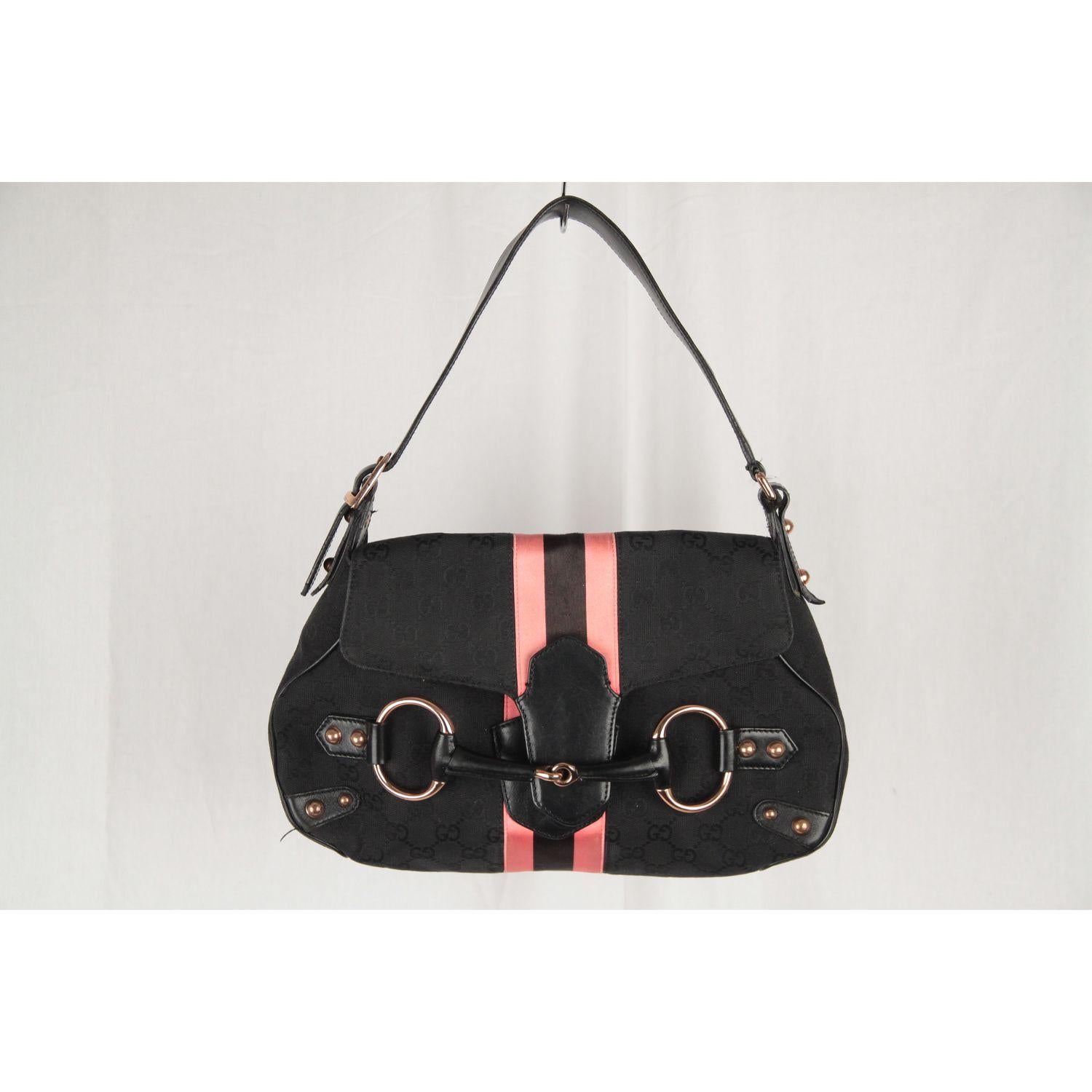 Rare Gucci shoulder bag from the TOM FORD Era. Black GG - GUCCI monogram pattern with Pink racing striped detail. 

Material: Canvas, Leather
Color: Black, Pink
Model: Shoulder Bag
Gender: Women
Country of Manufacture : Italy
Size: Medium

Bag