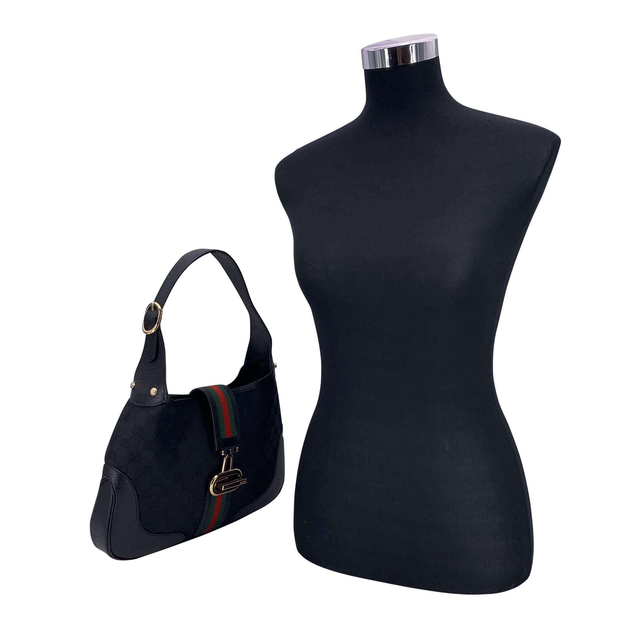 Effortlessly chic with a touch of vintage flair, this Gucci Black Monogram Canvas Hobo Bag is a standout piece that blends heritage design with everyday ease. Crafted from Gucci's iconic black GG monogram canvas and finished with sleek black leather