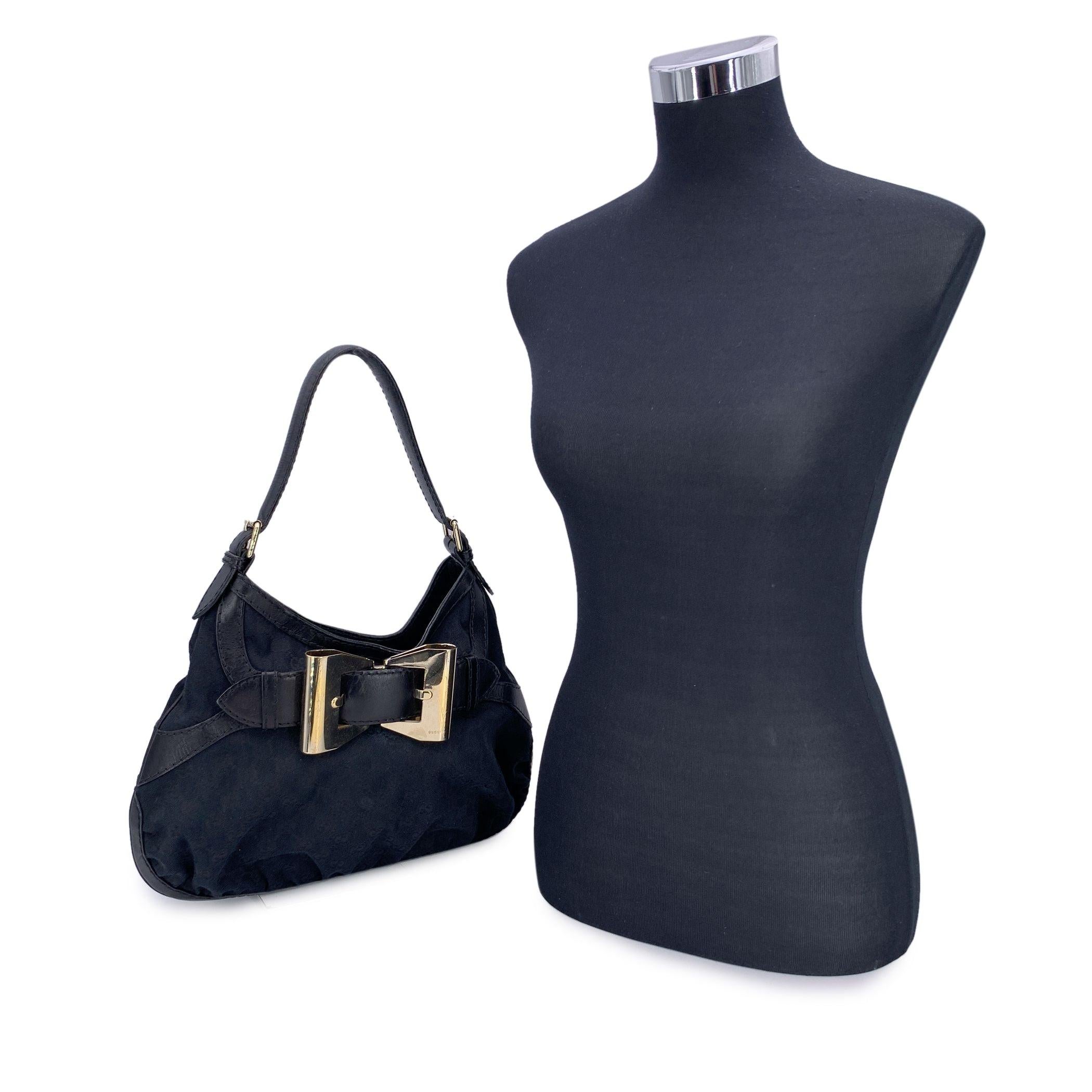 Introducing the stunning Gucci 'Queen' Hobo, a perfect blend of elegance and everyday practicality. This beautiful bag is crafted in sleek black monogram canvas, with black leather trim that gives it a refined and timeless look. A distinctive silver