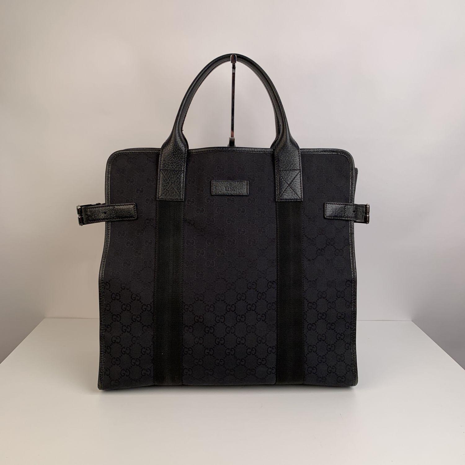 Beautiful Gucci tote Shopping bag made in black monogram canvas with blackleather trim and handles. Open top. Black fabric lining . 1 side zip pocket and 1 side open pocket inside. 'GUCCI- made in italy' tag inside (with serial number on its
