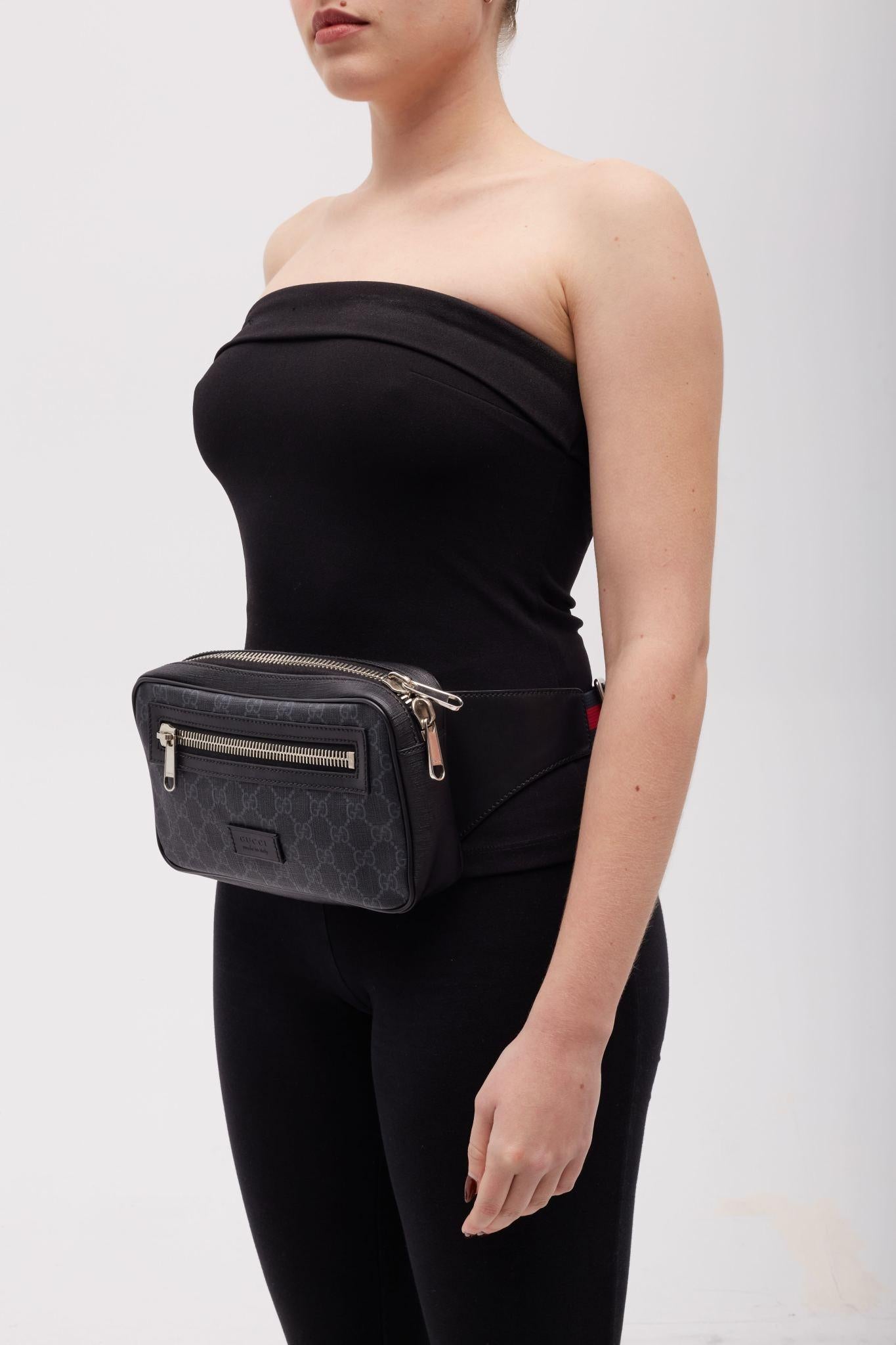 GUCCI BLACK MONOGRAM GG SUPREME WEB BELT BAG

This belt bag is finely made of coated black Gucci GG supreme canvas with monogram print. The bag features a front zipper pocket, an adjustable canvas red and blue web stripe strap and silver hardware.