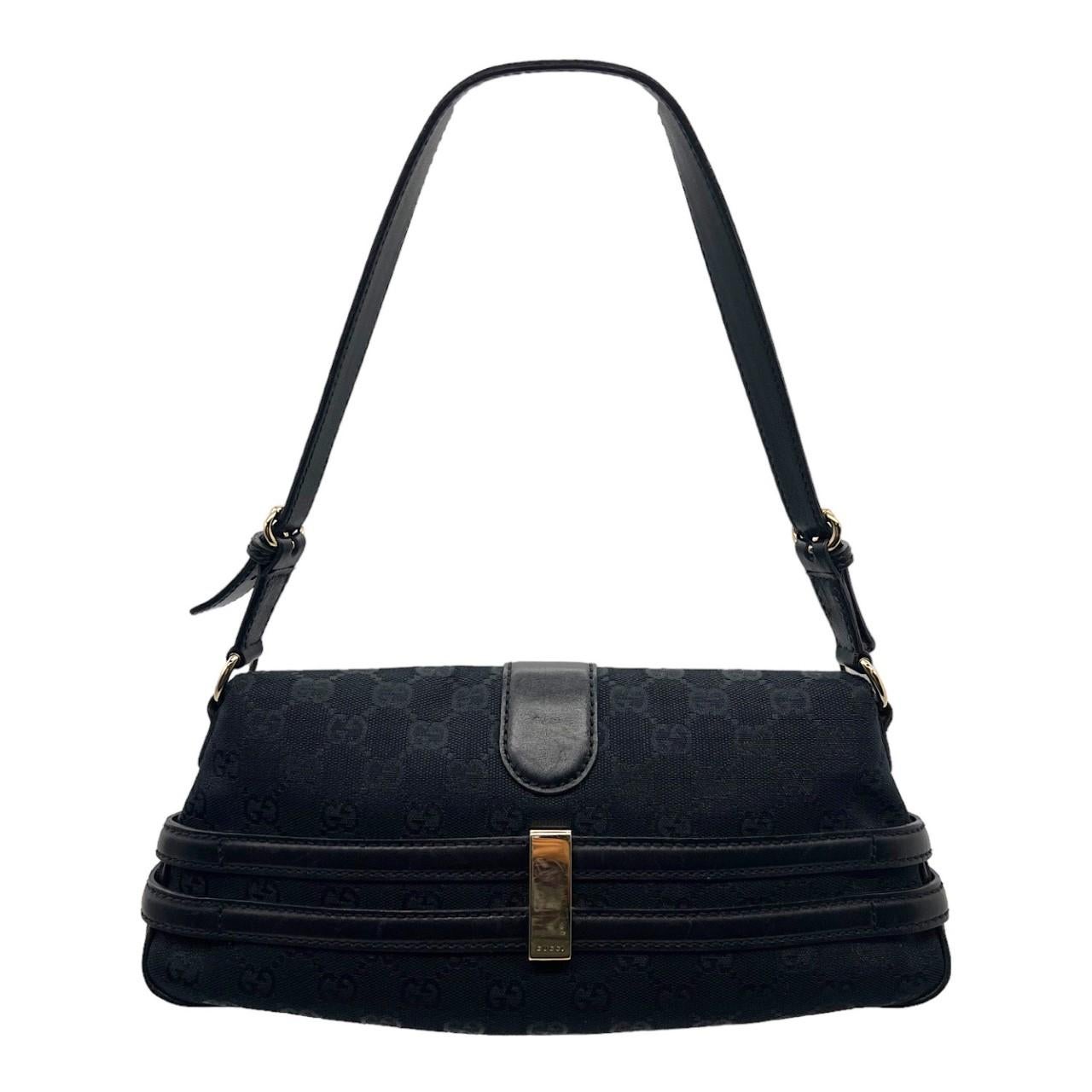 We are offering this black Gucci horsebit handbag. Made in Italy, it is crafted of black Gucci monogram canvas with black leather trims and silver-tone hardware accents. It has an adjustable black leather handle and it features an open fold-over