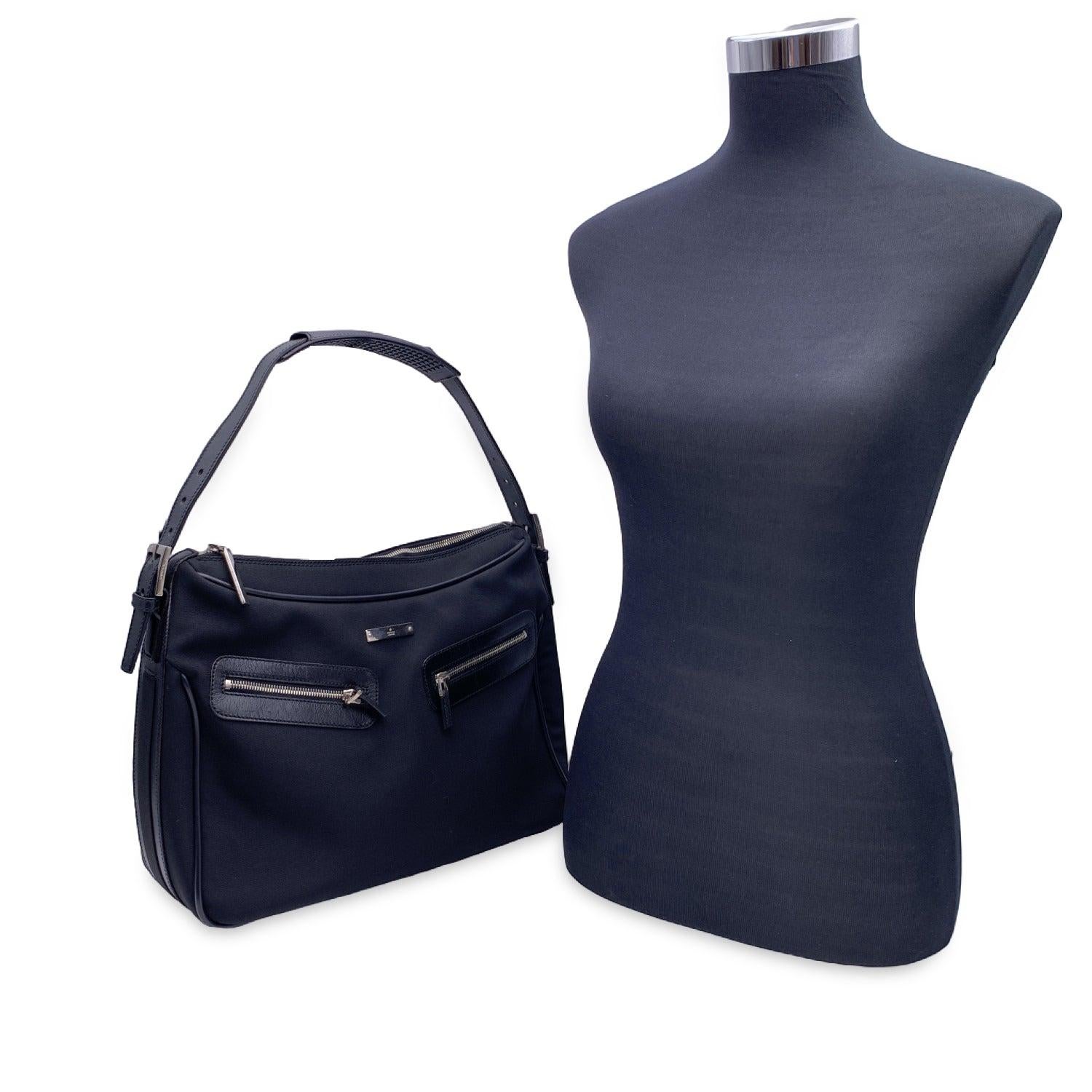 Step into the world of classic luxury with this beautiful Gucci shoulder bag, a perfect blend of style and practicality. Crafted in sleek black nylon canvas with refined black leather trim, this bag is the ideal companion for those who appreciate