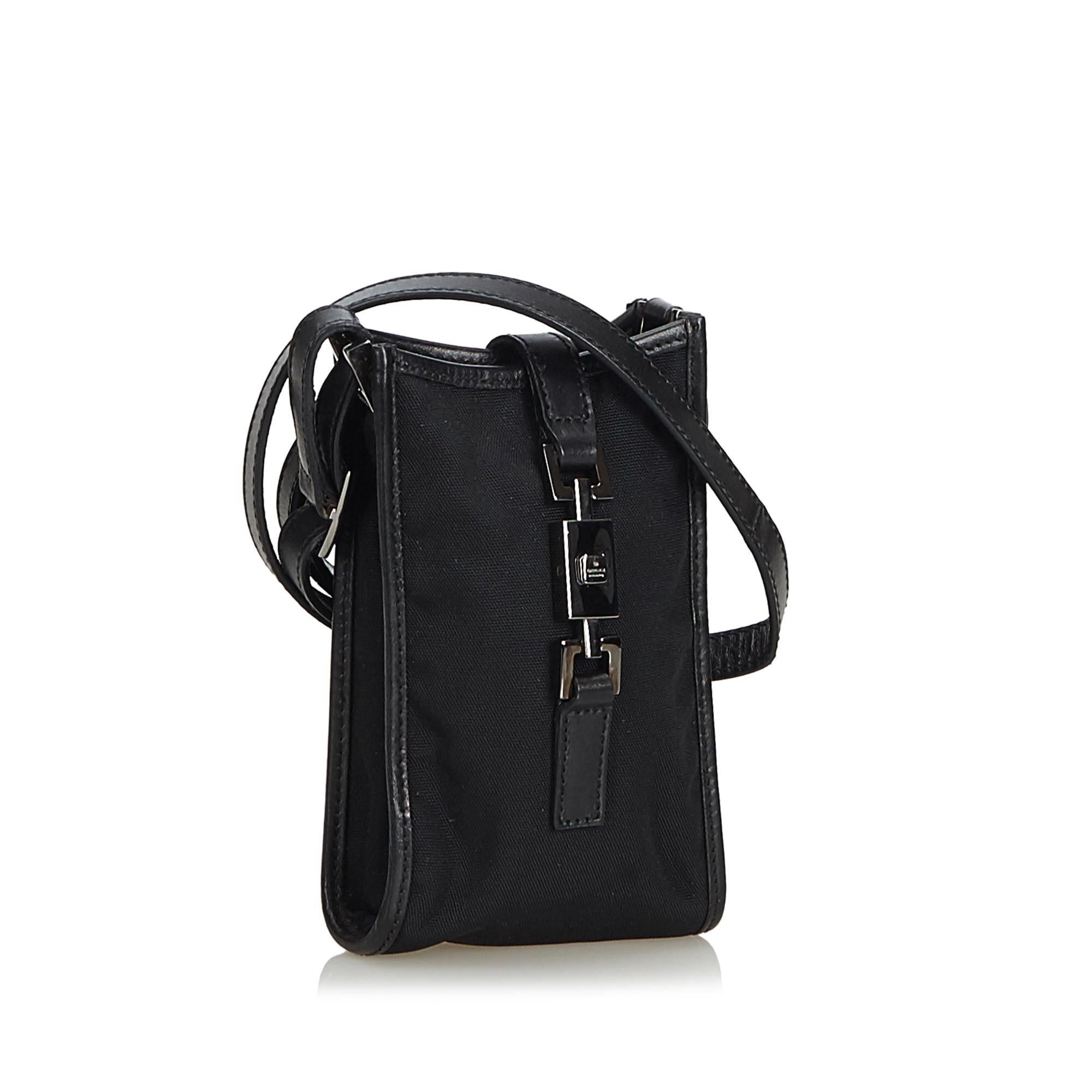 This crossbody bag features a nylon body, a flat adjustable leather strap, and an open top with a fold over flat strap with metal details. It carries as B+ condition rating.

Inclusions: 
This item does not come with inclusions.

Dimensions:
Length: