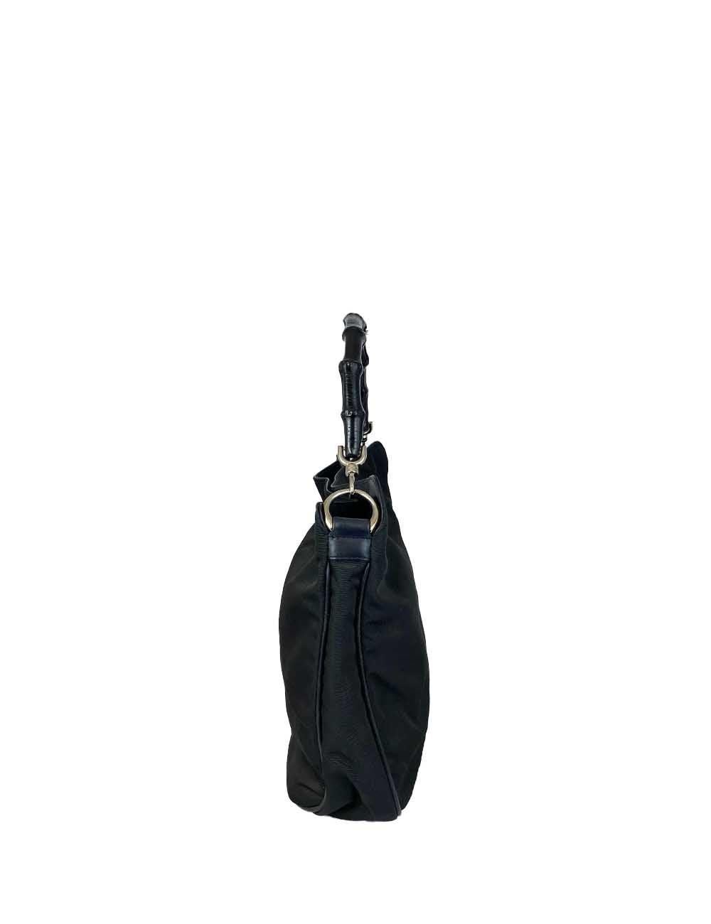 Black nylon Gucci handle bag with black bamboo handle and silver hardware. One zipper pocket on the inside and leather bottom. 

Additional information:
Material: Nylon
Hardware: Silver
Measurements: 30 W x 5 D x 26 H cm
Handle Drop: 13 cm 
Overall