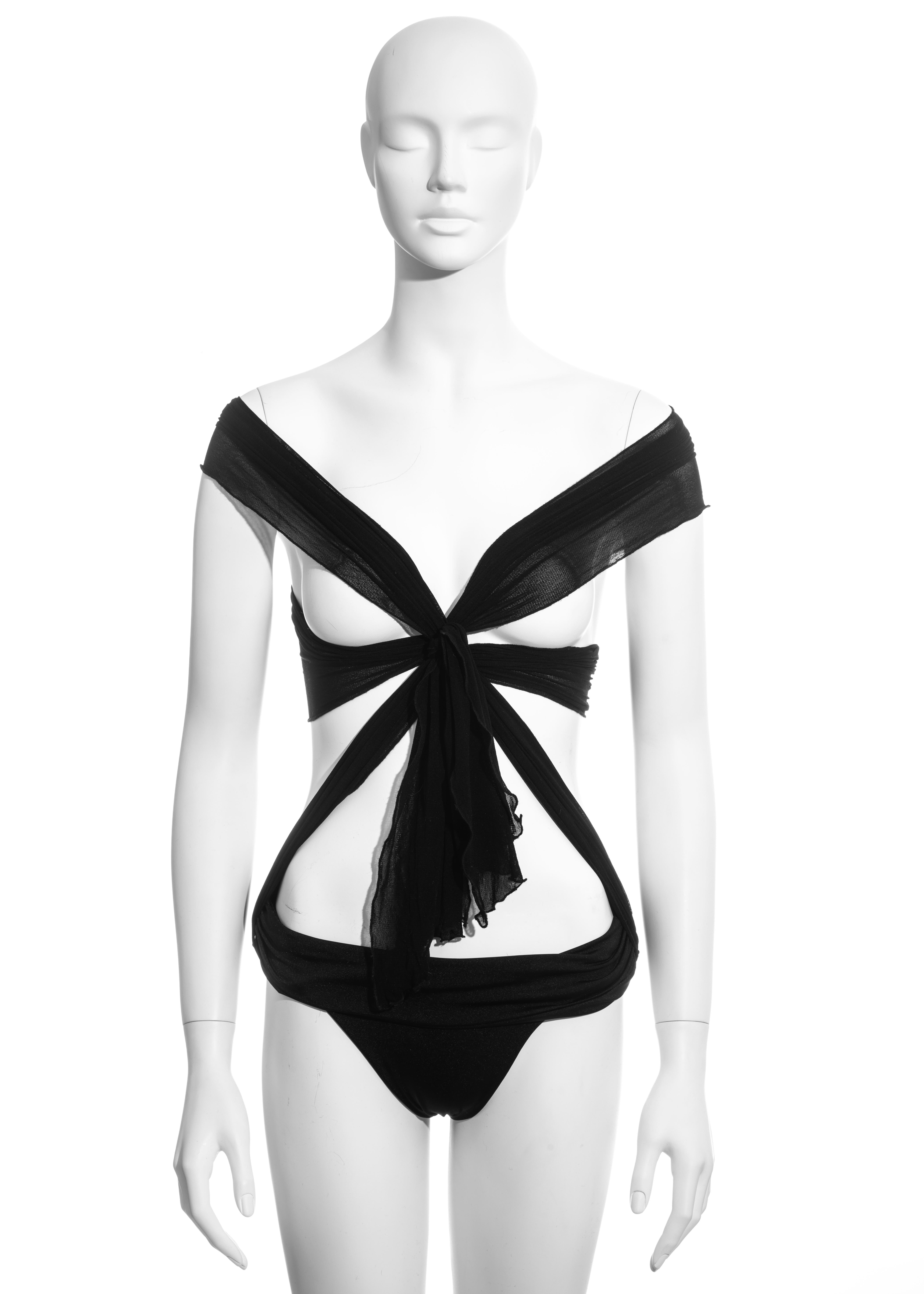 ▪ Gucci black bodysuit 
▪ Two tie-up fastenings placed on the hips; can be styled in multiple ways 
▪ Can be worn as swimwear or evening wear  
▪ 90% Nylon, 10% Elastane 
▪ Size Medium
▪ Spring-Summer 2005