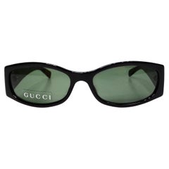 Lunettes de soleil Gucci à monture ovale noire et verres teintés verts circa 1999