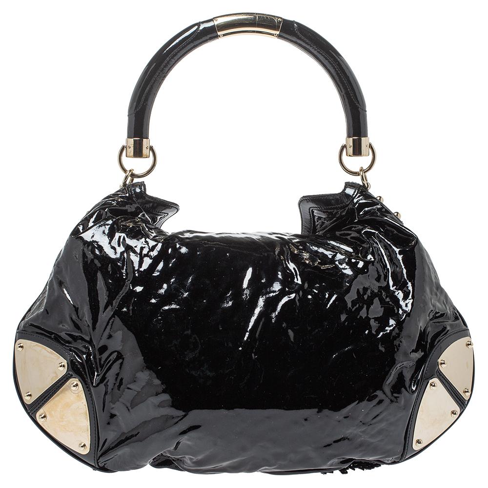 An adorable Indy Hobo from Gucci to think about! Crafted with patent leather & suede, the highlight of the bag is the large fur tassels that drop from the flap and work as a closure. Armored plates and a structured top handle with gold-tone loops