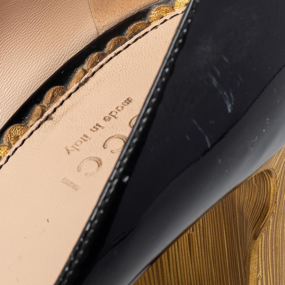 These Gucci pumps come in a mary jane silhouette and are as feminine and stylish as they can get— thanks to the logo-accented pearl button closure and gold-tone curved heels. With round toes, glossy patent leather construction, and a black shade,