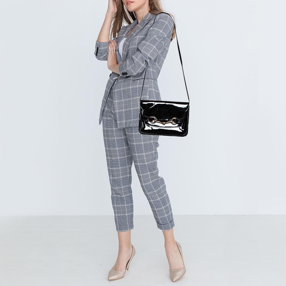 This Bright Bit bag from Gucci proves that style can come in simple things too. Crafted from patent leather, this lovely black bag features a canvas-lined interior and a long shoulder strap. It is finished with a gold-tone signature Horsebit on the
