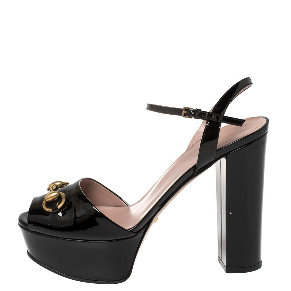 Adorned by celebrities worldwide, Gucci's Claudie sandals are timeless. Crafted from patent leather in a versatile black shade, they feature Horsebit accents in gold tone for a signature. The sandals are elevated on 12.5 cm block heels supported by