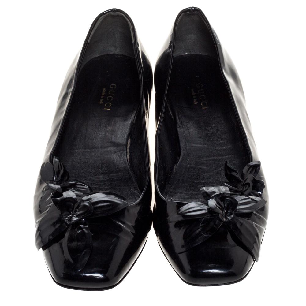 Now here is one pair you'll definitely love wearing! These black ballet flats from Gucci impress with their patent leather construction that is enhanced with square toes and flower embellishments on the vamps. They'll make your feet happy with their
