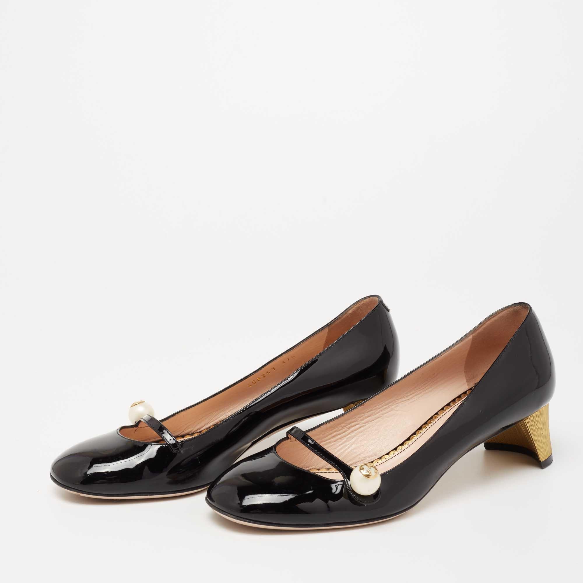 These Gucci pumps come in a mary jane silhouette and are as feminine and stylish as they can get— thanks to the logo-accented pearl button closure and gold-tone heels. With round toes, glossy patent leather construction, and a black shade, these