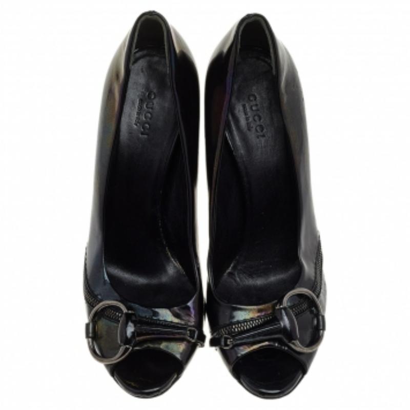 These Gucci beauties are crafted from black patent leather and feature a peep-toe design. They flaunt signature Horsebit detailing on the front, have a comfortable leather-lined insole, and are complete with tall heels.