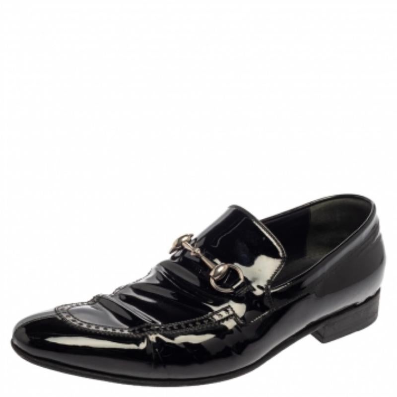 Project an ultra-stylish look in these black loafers from Gucci! They have been crafted from patent leather and designed with almond toes and the signature Horsebit accents on the vamps. They are complete with comfortable leather-lined insoles and