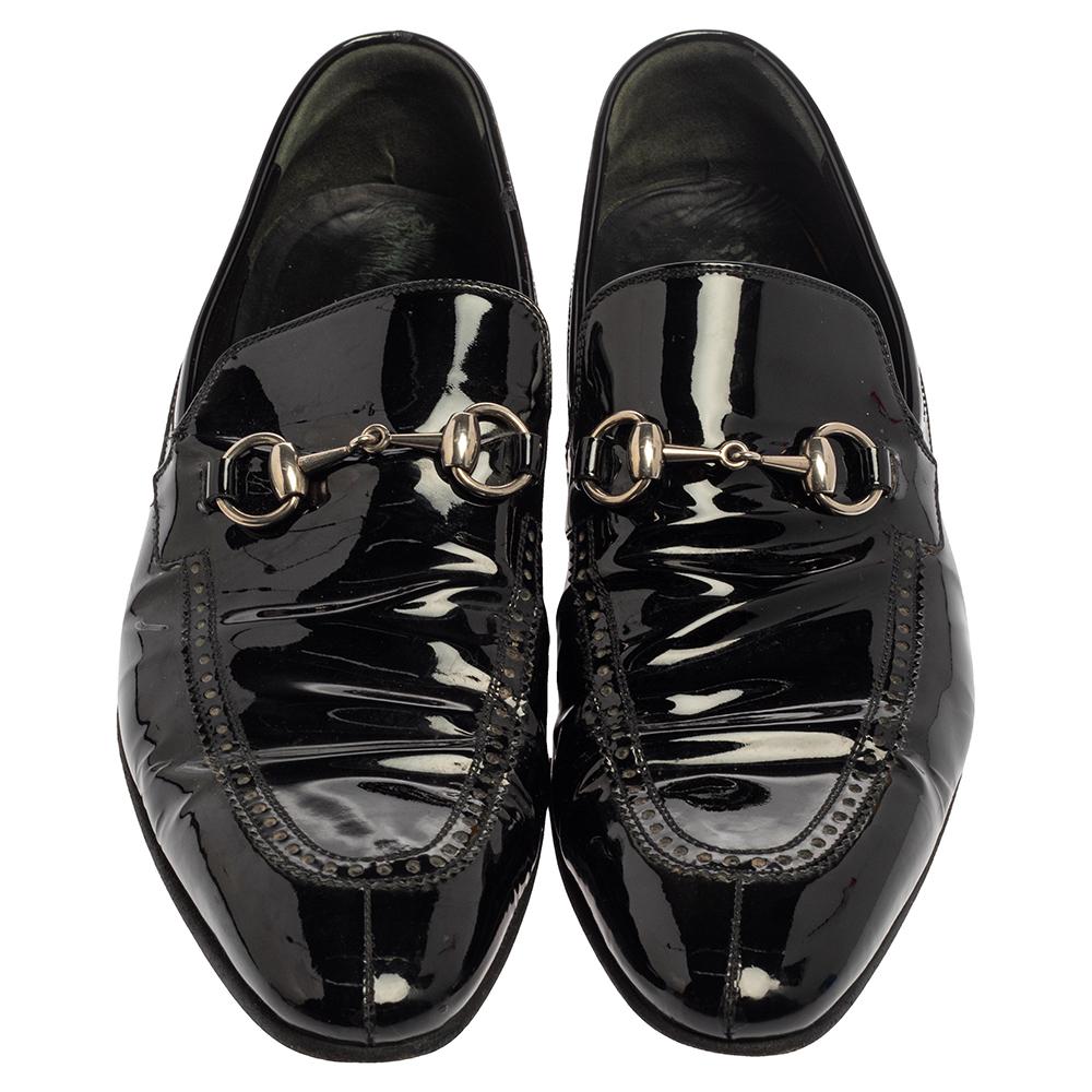 Project an ultra-stylish look in these black loafers from Gucci! They have been crafted from patent leather and designed with almond toes and the signature Horsebit accents on the vamps. They are complete with comfortable leather-lined insoles and