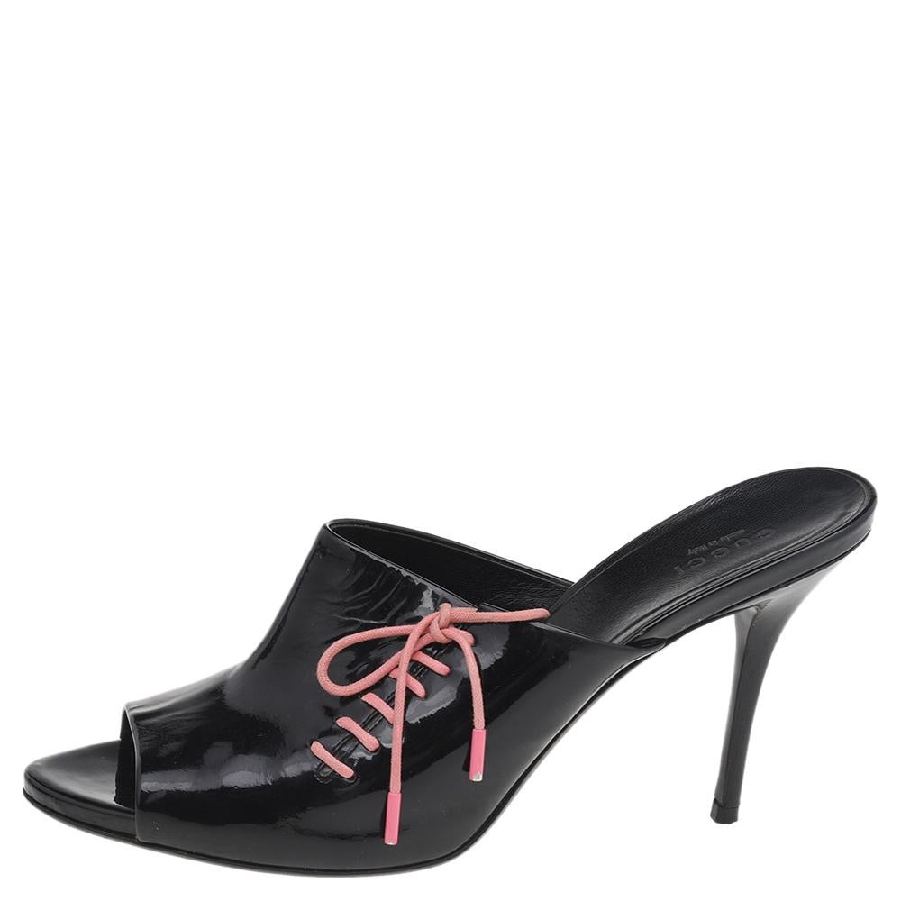 Crafted beautifully from patent leather and lifted on slim heels, these black peep-toe mules will be an elegant addition to your wardrobe. This pair by Gucci is characterized by lace-up detailing on the uppers.

Includes: Original Dustbag