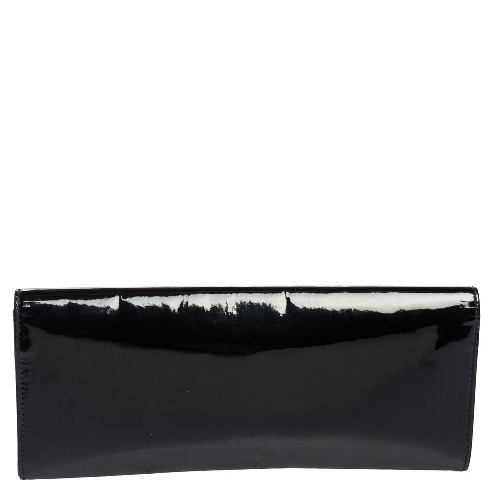 Highlight your outfit with this classic Romy clutch by Gucci. The black patent leather exterior is accented with a gold-tone buckle detailing. The snap magnetic closure opens to a satin-lined interior.


Includes: Original Dustbag