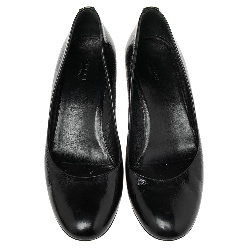 These black pumps from Gucci are simple but a must-have. Crafted using patent leather, and balanced on wedge heels, the round-toe pumps are complete with the logo on the counters. They are high in both style and comfort.

Includes: Original Dustbag