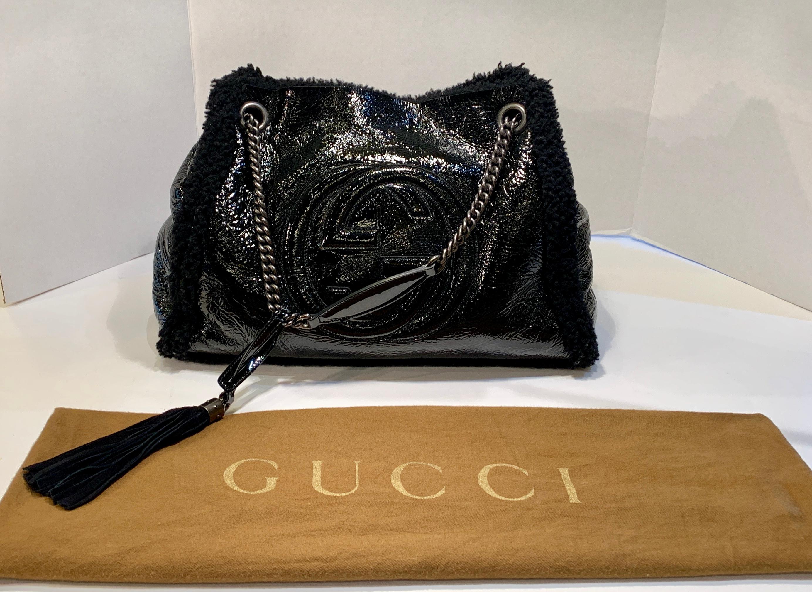 Wonderful, soft and unstructured GUCCI statement tote bag or purse is made of stylish crinkle black patent leather with the large, embossed interlocking GUCCI 