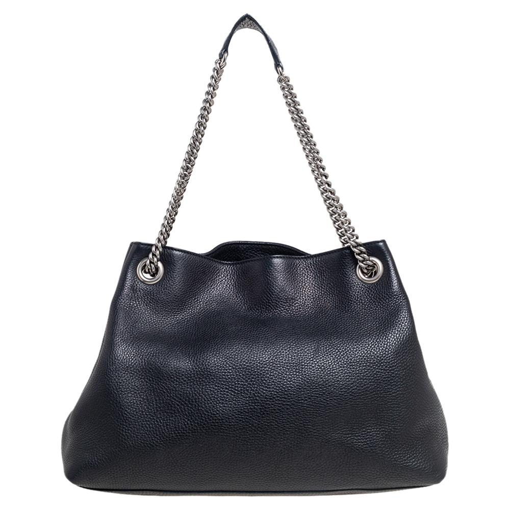 This Soho tote is one of the many designs by Gucci that is loved by women worldwide. The bag is constructed from pebbled leather and designed with a studded GG logo on the front. It features a spacious canvas interior for your essentials, two chain
