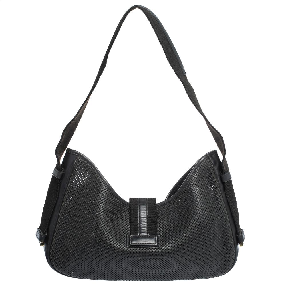 Gucci is known for its standard designing and designs. Make a stunning addition to your accessory collection with this rich and fabulous perforated leather and canvas handbag. It comes in a classic shade of black. It has a single handle, a strap