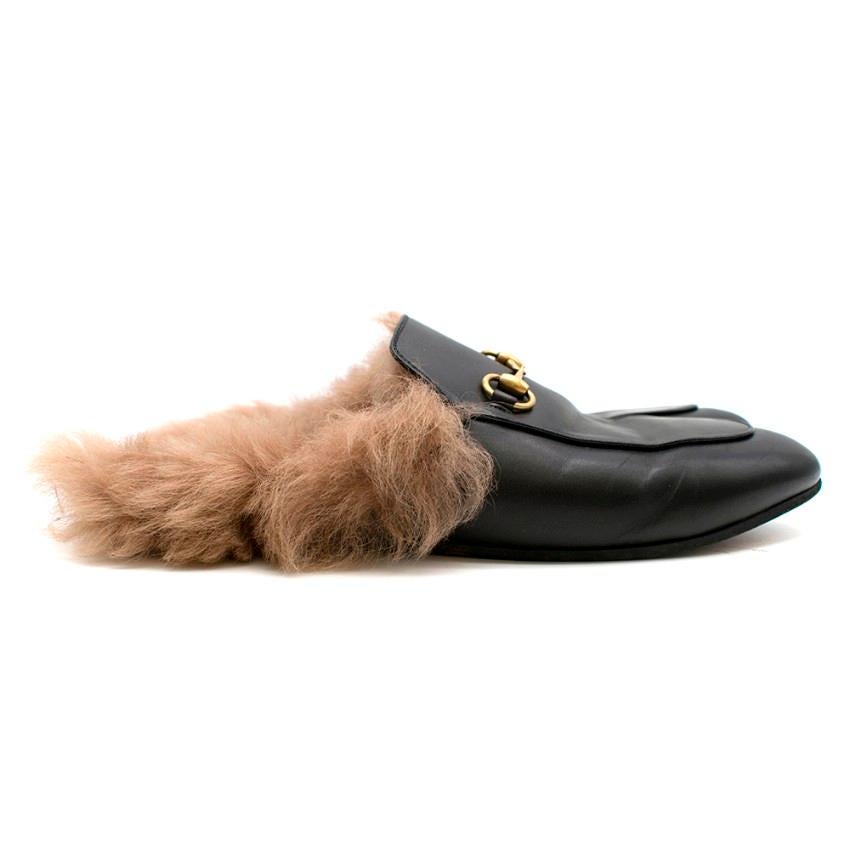 Black Princetown Leather Fur Lined Mules

- Fur lined
- Backless slide on
- Gold-tone signature horse-bit 
- Rounded toe 
- Small stacked heel  

Made in Italy

Materials 
Outer: Leather 100%
Sole: Leather 100%
Lining: Lamb Fur 100%

Please note,