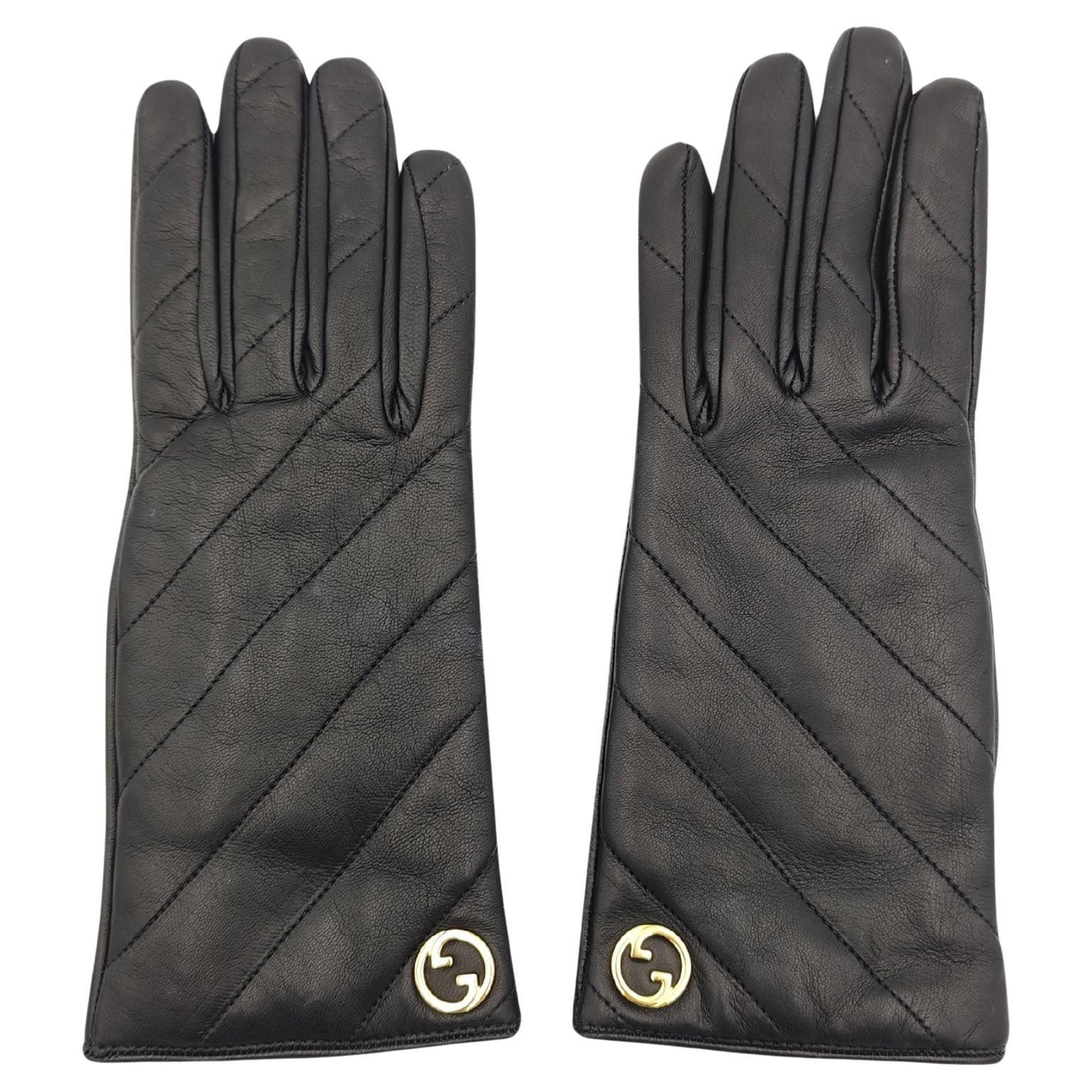 Guanti Gucci in pelle nera trapuntata con logo dorato