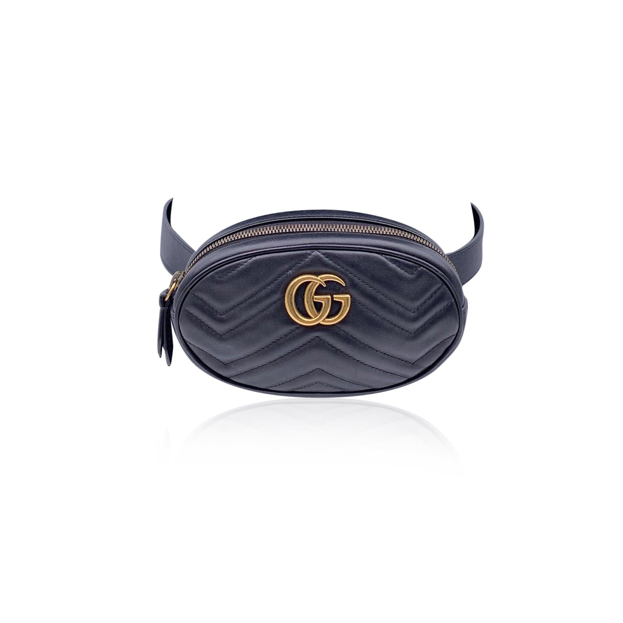 Gucci GG Marmont Belt Bag. in black leather. Chevron quilted leather. Gold metal GG logo on the front. Upper zip closure. 1 open pocket inside. Lined interior. Adjustable belt strap. Size: 65/26 - Size 34 IT. 'Gucci - Made in Italy' tag inside (with