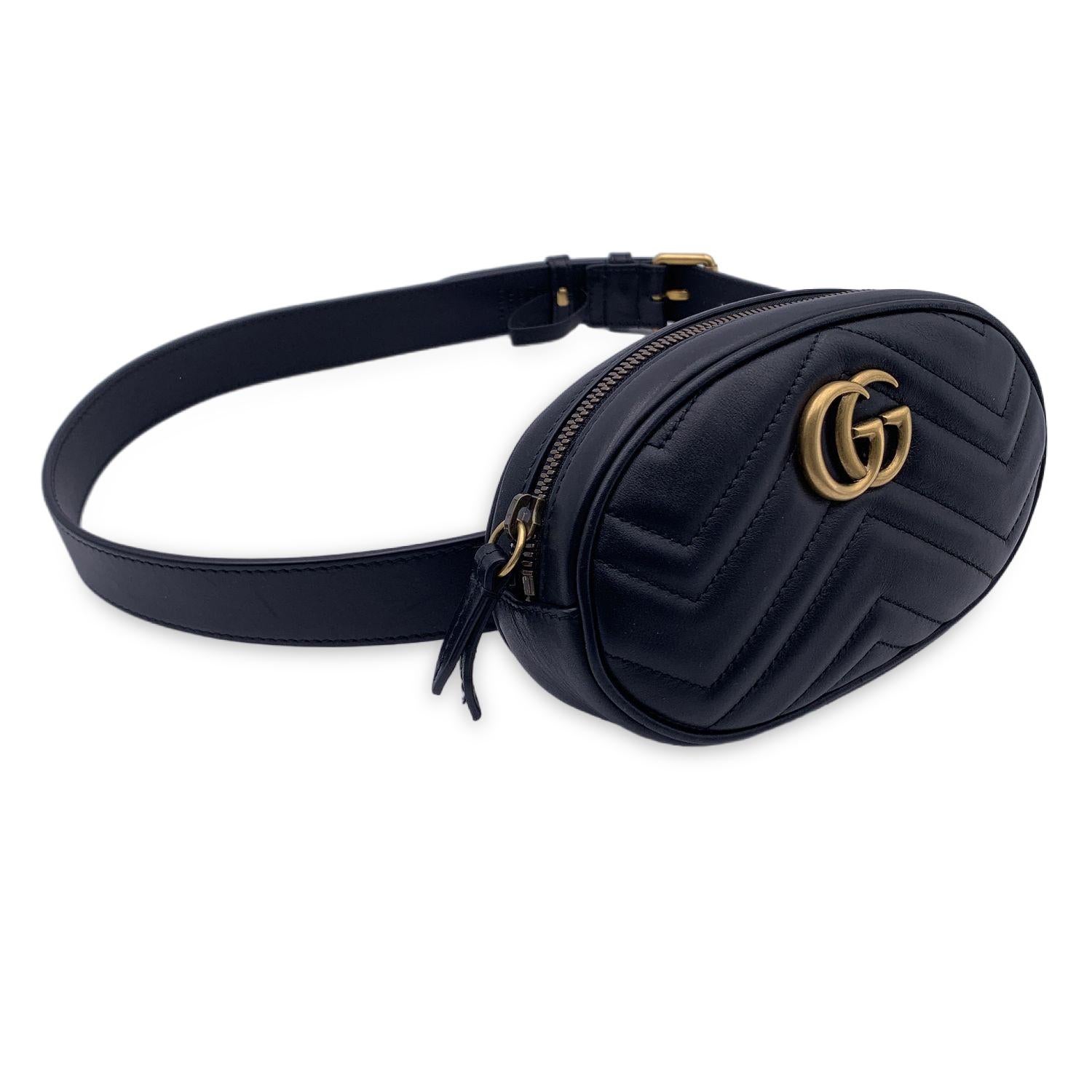 Gucci GG Marmont Belt Bag. in black leather. Chevron quilted leather. Gold metal GG logo on the front. Upper zip closure. 1 open pocket inside. Lined interior. Adjustable belt strap. Size: 85/34. 'Gucci - Made in Italy' tag inside (with serial