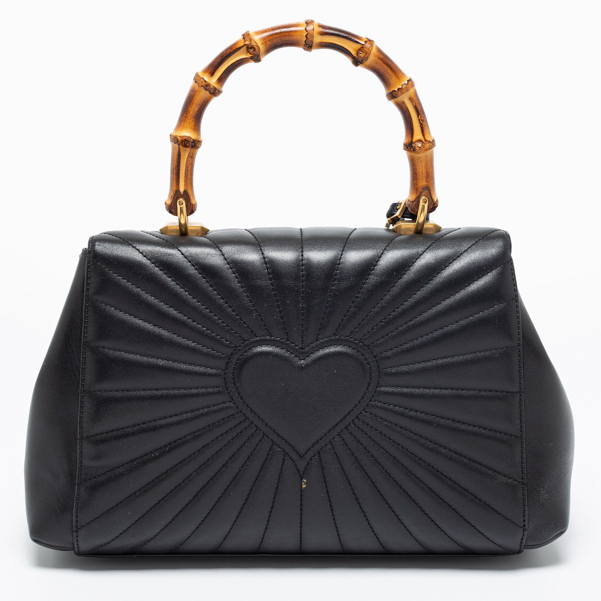 Coming from Gucci, this impeccable Queen Margaret bag is a luxurious piece you need to own today. It is made from black quilted leather, with the iconic Bamboo handle perched on the top. Encrusted with a studded Bee motif, it flaunts gold-toned