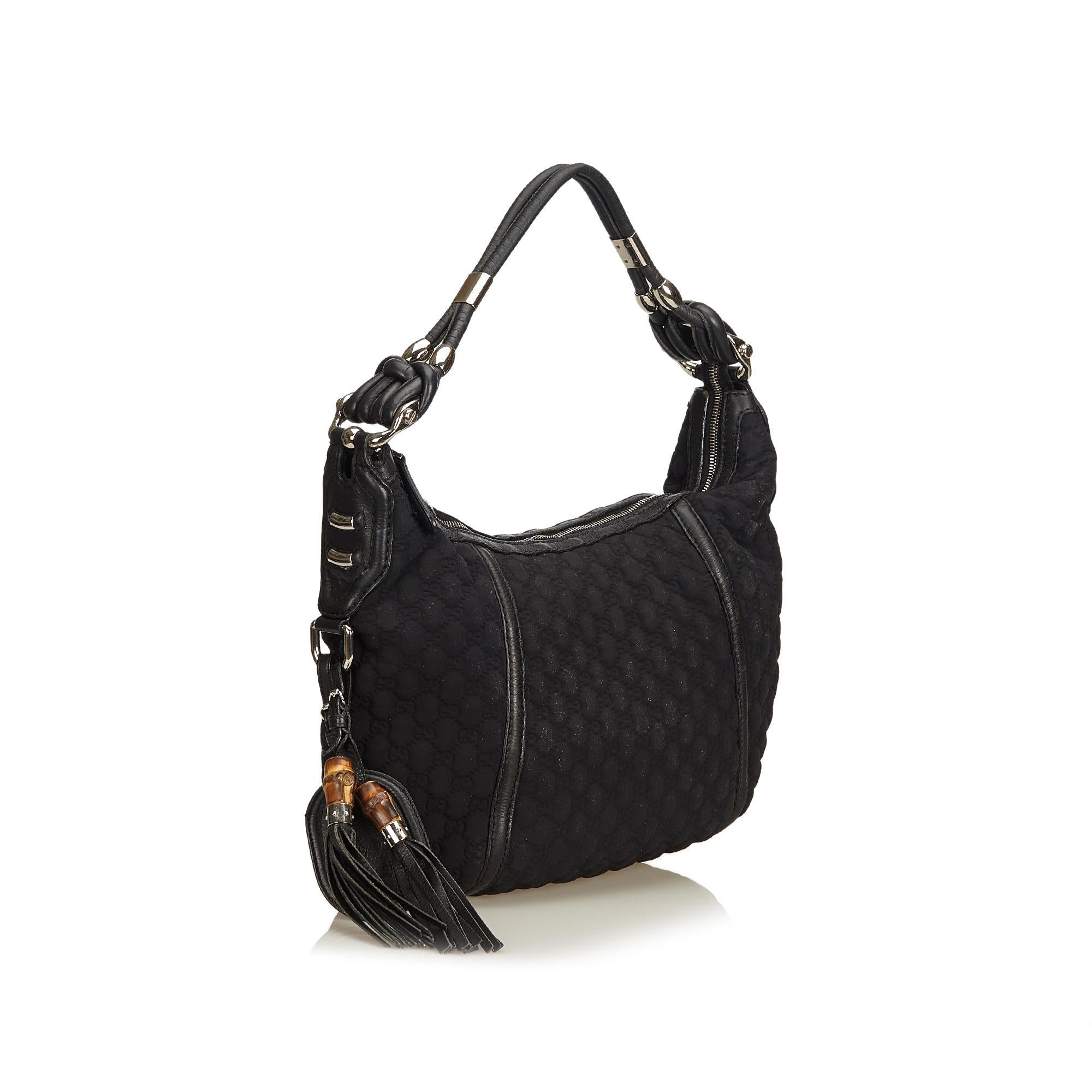 This Techno hobo bag features a quilted nylon body, rolled leather strap, top zip closure, tassel detail, and interior zip pocket. It carries as B condition rating.

Inclusions: 
This item does not come with inclusions.

Dimensions:
Length: 33.00