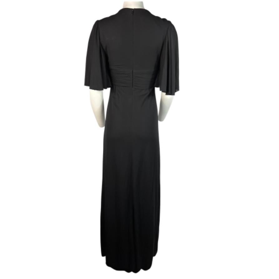 A gorgeous Gucci maxi dress gown, made of rayon and silk, size small.
This opulent dress features a few remarkable details that make this dress to look as a statement.
The dress is adorned with a crystal bow and two large buttons. These elements