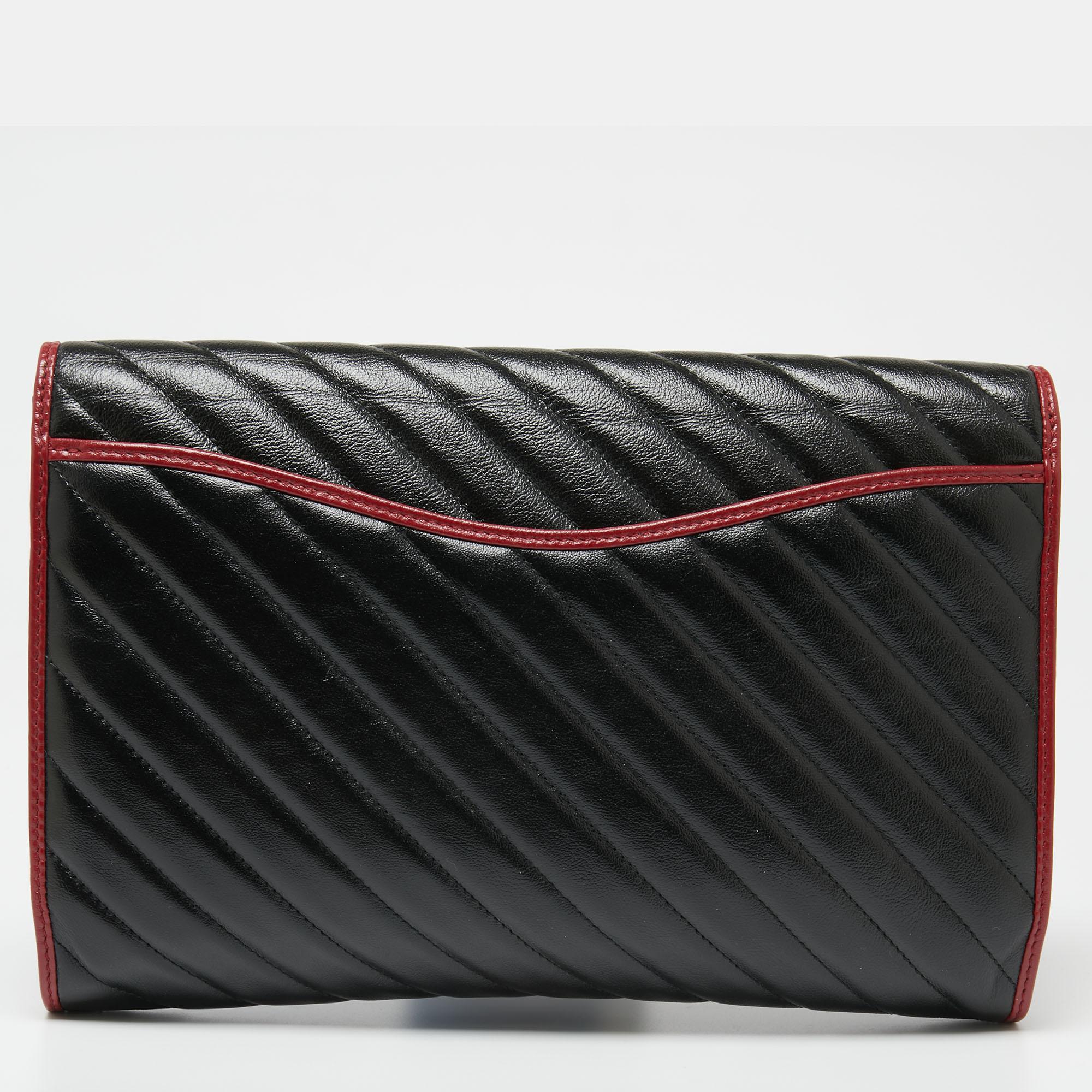 This black clutch has been exquisitely crafted from diagonal-quilted leather and is equipped with a well-sized suede interior. On the front flap, there is a gold-tone GG logo. Make this Gucci creation yours today!

Includes: Original Dustbag, Info