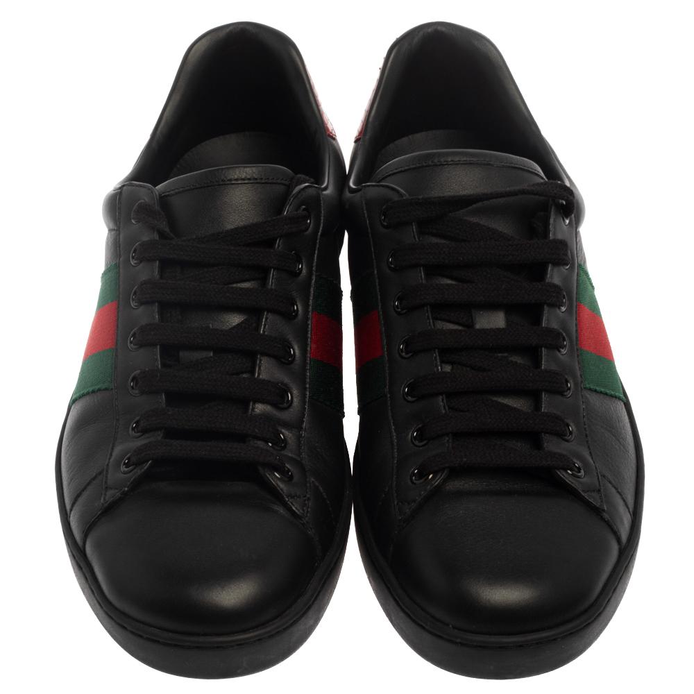 Stacked with signature details, this Gucci pair is rendered in leather and is designed in a low-cut style with lace-up vamps. The black sneakers have been fashioned with the iconic Web stripes on the sides. Complete with red trims carrying the brand