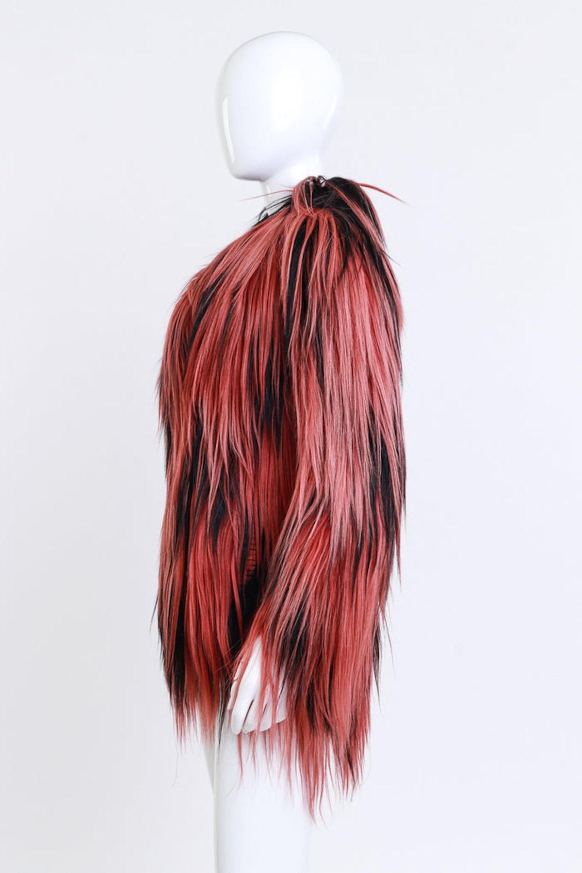 GUCCI BLACK RED LONG GOAT FUR JACKET (S/M)

This Gucci long goat fur jacket is from the 2015 Pre-Fall collection. The luxurious two-tone design features plush goat fur in black and rose mauve. It has a structured notch collar, four hook closures at