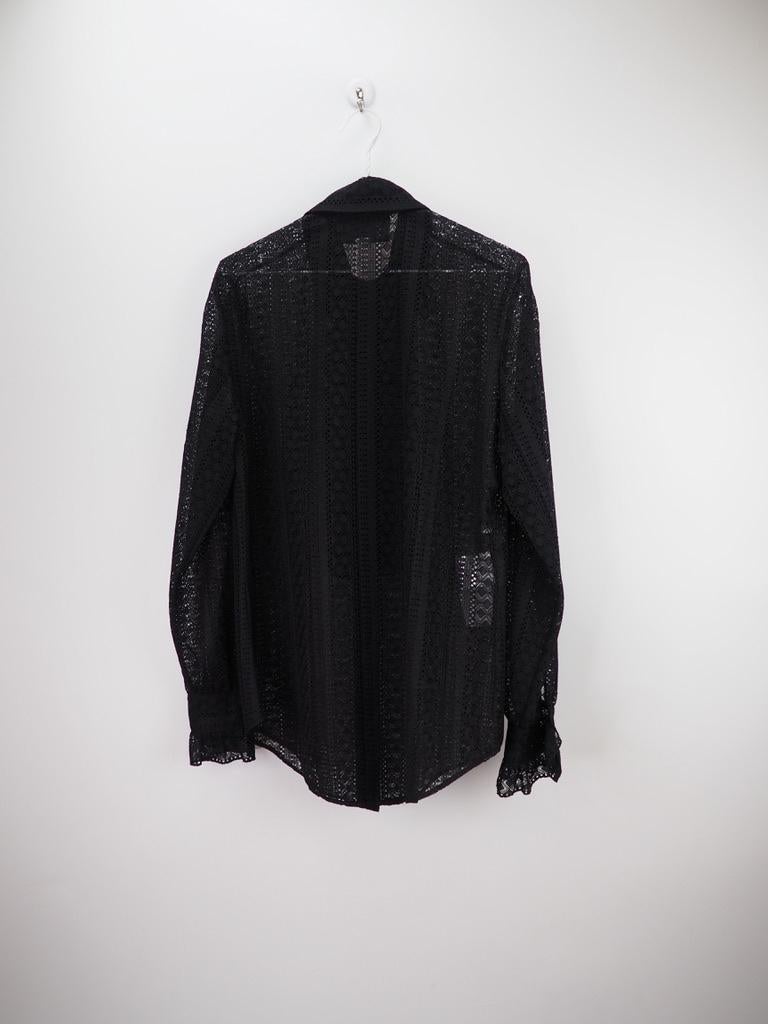 Gucci Striped Lace Shirt with long sleeves, a classic collar, a ruffle to the chest and a lace construction. Gucci’s creative director has famously transformed the fashion house without disregarding the brand’s history. He mixes the old with the