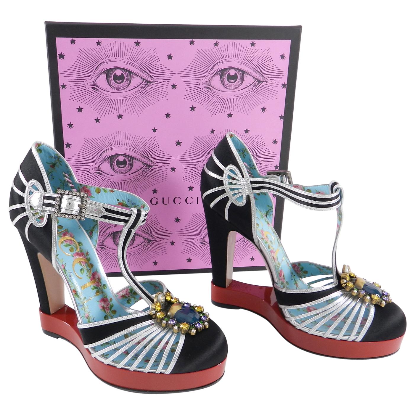 Gucci Black Satin and Silver T-Strap Pump Red Platform with Jewels.  Original retail $1690 USD. Blue floral leather interior with black satin and silver leather trimmed exterior.  Dramatic red resin platform base. Clear rhinestone buckle at ankle