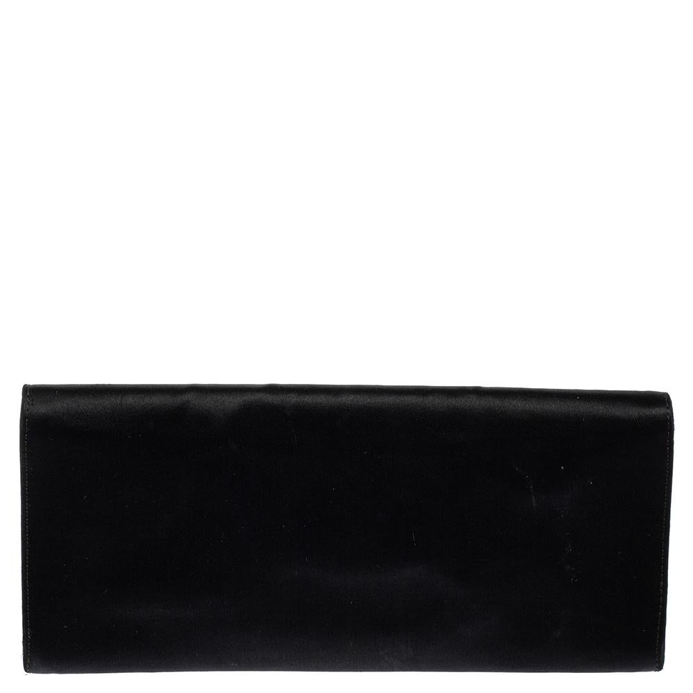 Gucci's flap clutch is crafted from black satin and has an elegant shape. The flap opens to a satin-lined interior that will easily fit your party essentials. This clutch is perfect to be teamed up with evening attire and is a must-have in your