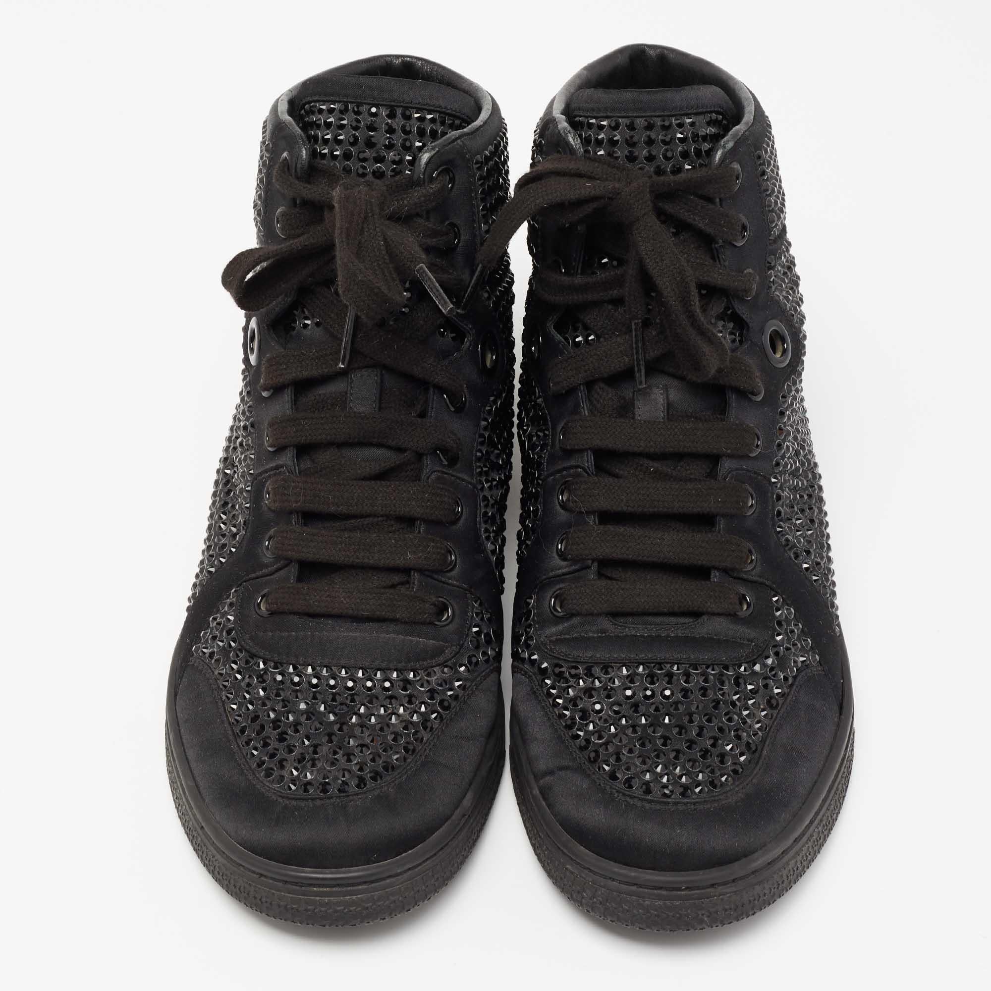 Amp up your casual style as you wear these high-top sneakers from the House of Gucci. Black satin material is used to create its sturdy exterior. To add to its beauty, crystal embellishments and matching black-toned hardware are used to decorate the